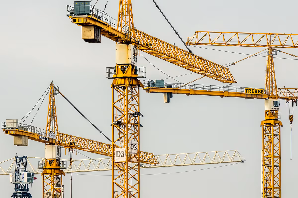 Crane lifting materials suggesting agents accelerate delivery inside guardrails.