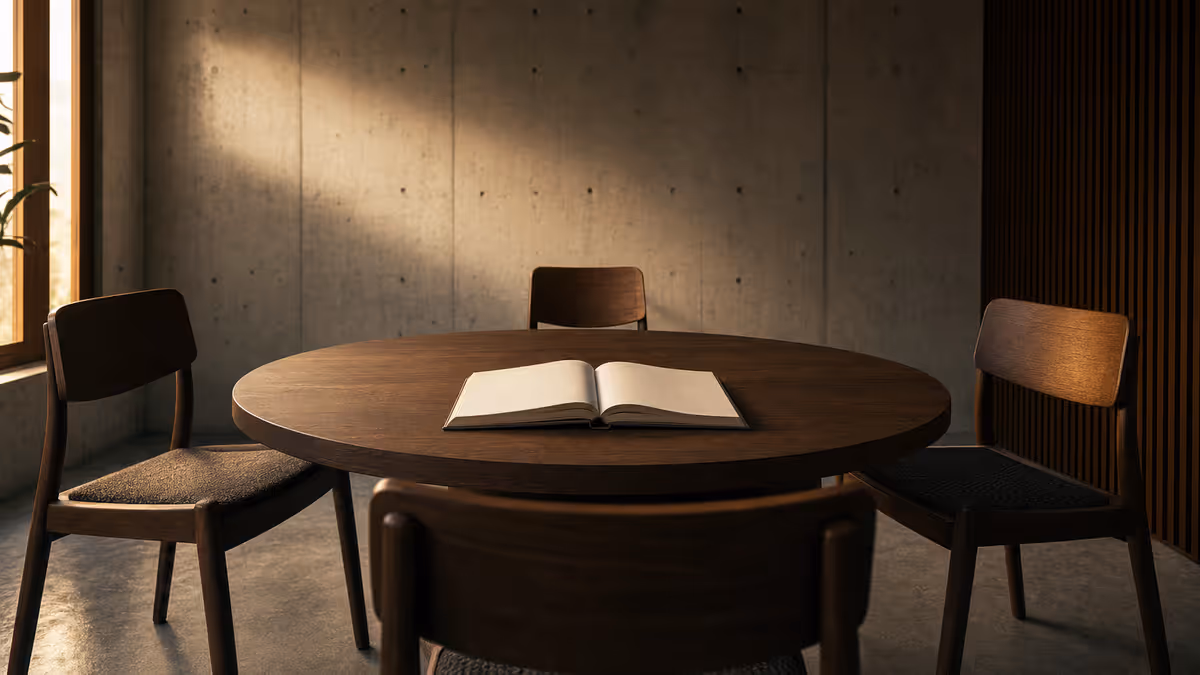 Cinematic 16:9 low-angle of a single chair at a round table, three empty